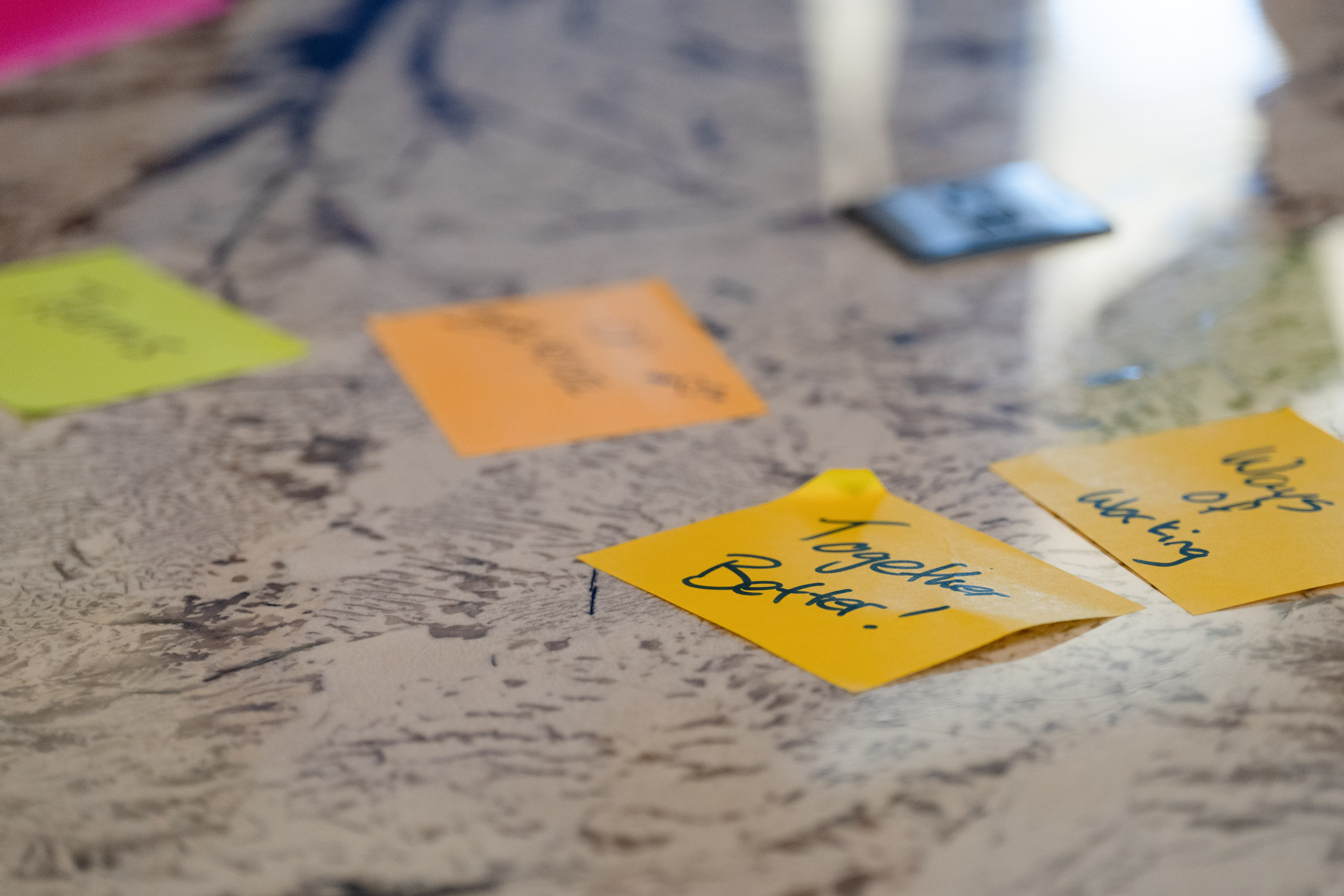 Team gathered around a table with laptops overhead view